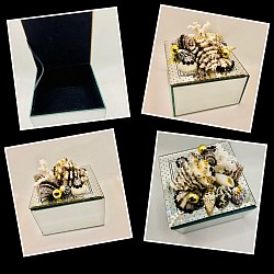 Pictures dodo it justice with this beautiful mirrored jewelry box embellished with real coral, seashells and rhinestones. Black and gold are the perfect combo for this piece. 4 3/4”x 4 3/4”x 4 3/4” H.    $30