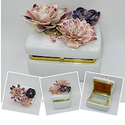 Small porcelain music box that plays Memories. The flowers on top are intricately made with tiny seashells, naturally beautiful! 3.5”Wx2.5”Dx3.25”T  $30